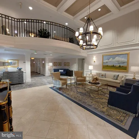 a living room with fireplace furniture and a chandelier