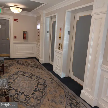 an empty room with wooden floor door and windows