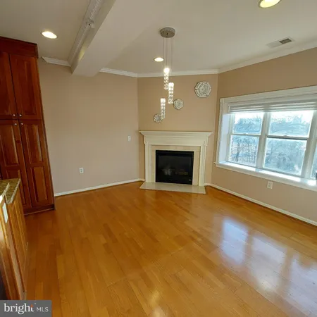 an empty room with windows and fireplace