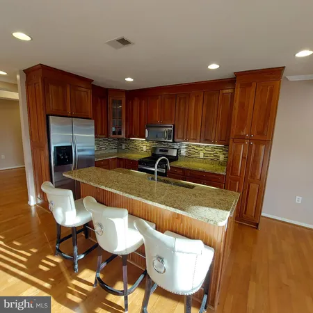 a view of a dining room with furniture a chandelier and wooden floor