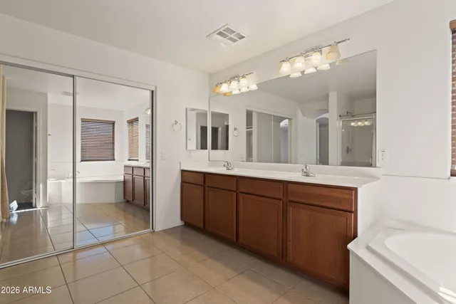 a bathroom with a sink a mirror and a shower