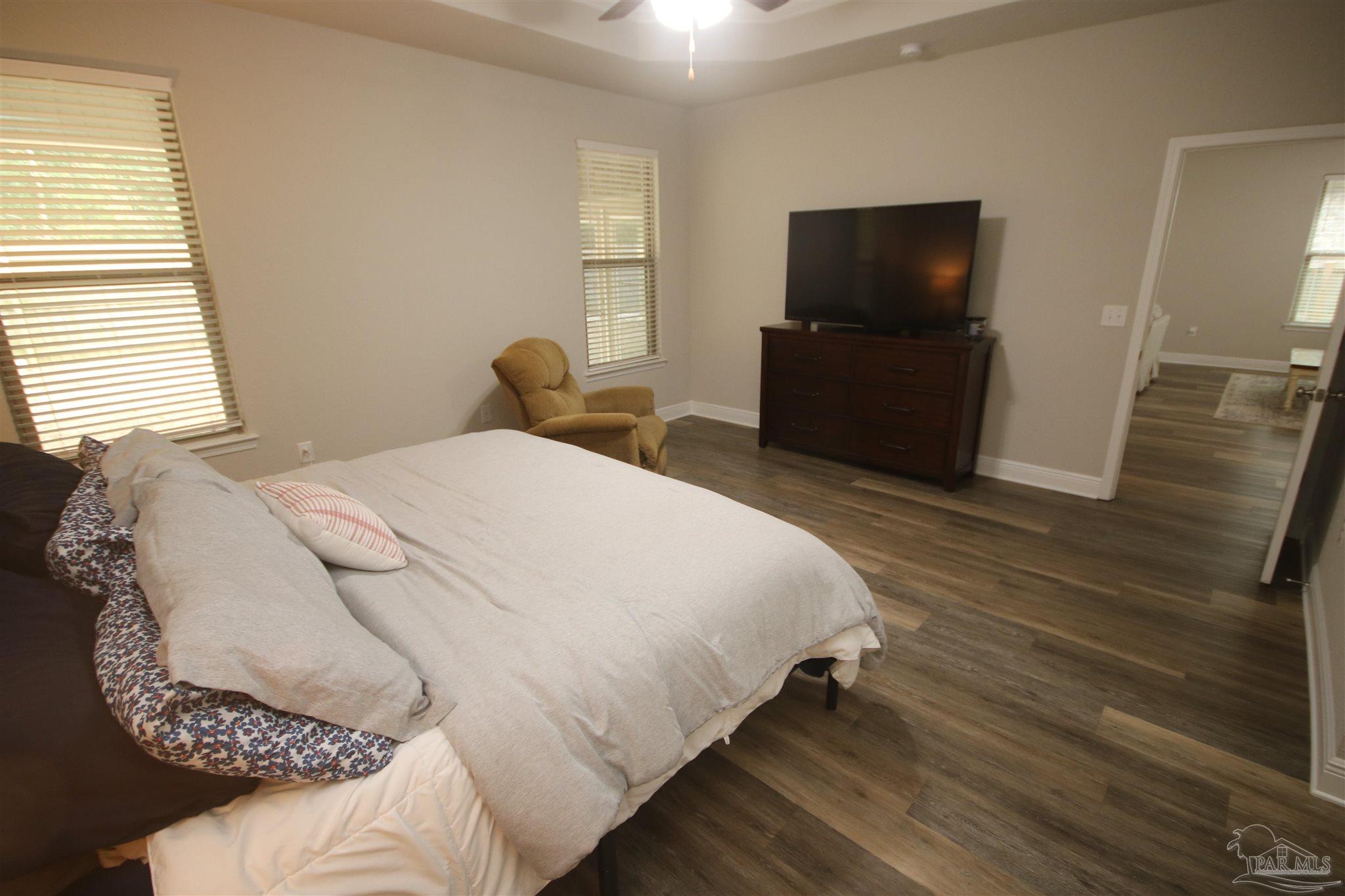3849 Ranch Road Pace, FL 32571 - Photo 28 of 56 a bedroom with a bed and a flat screen tv