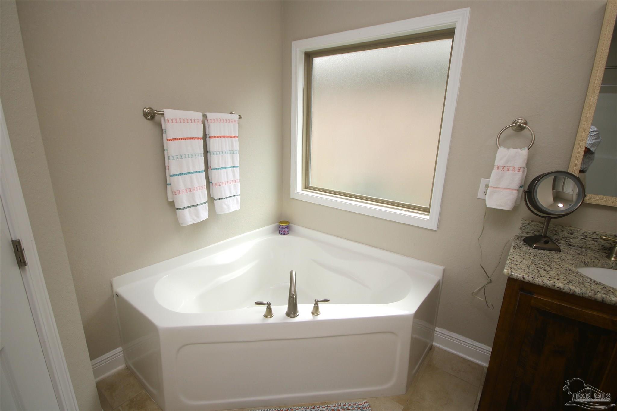3849 Ranch Road Pace, FL 32571 - Photo 33 of 56 a white bath tub sitting next to a window