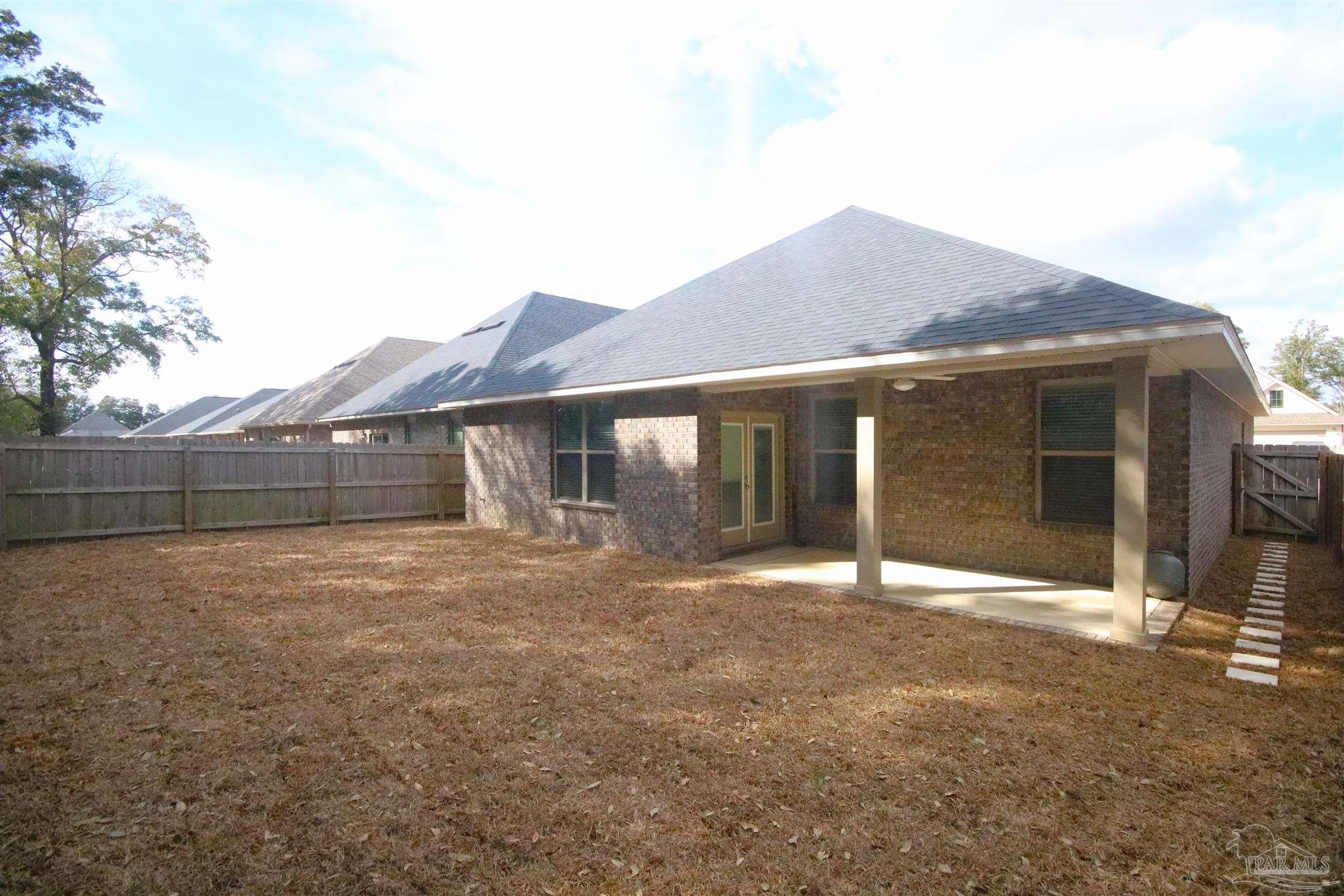 3849 Ranch Road Pace, FL 32571 - Photo 55 of 56 a front view of a house with a yard and garage
