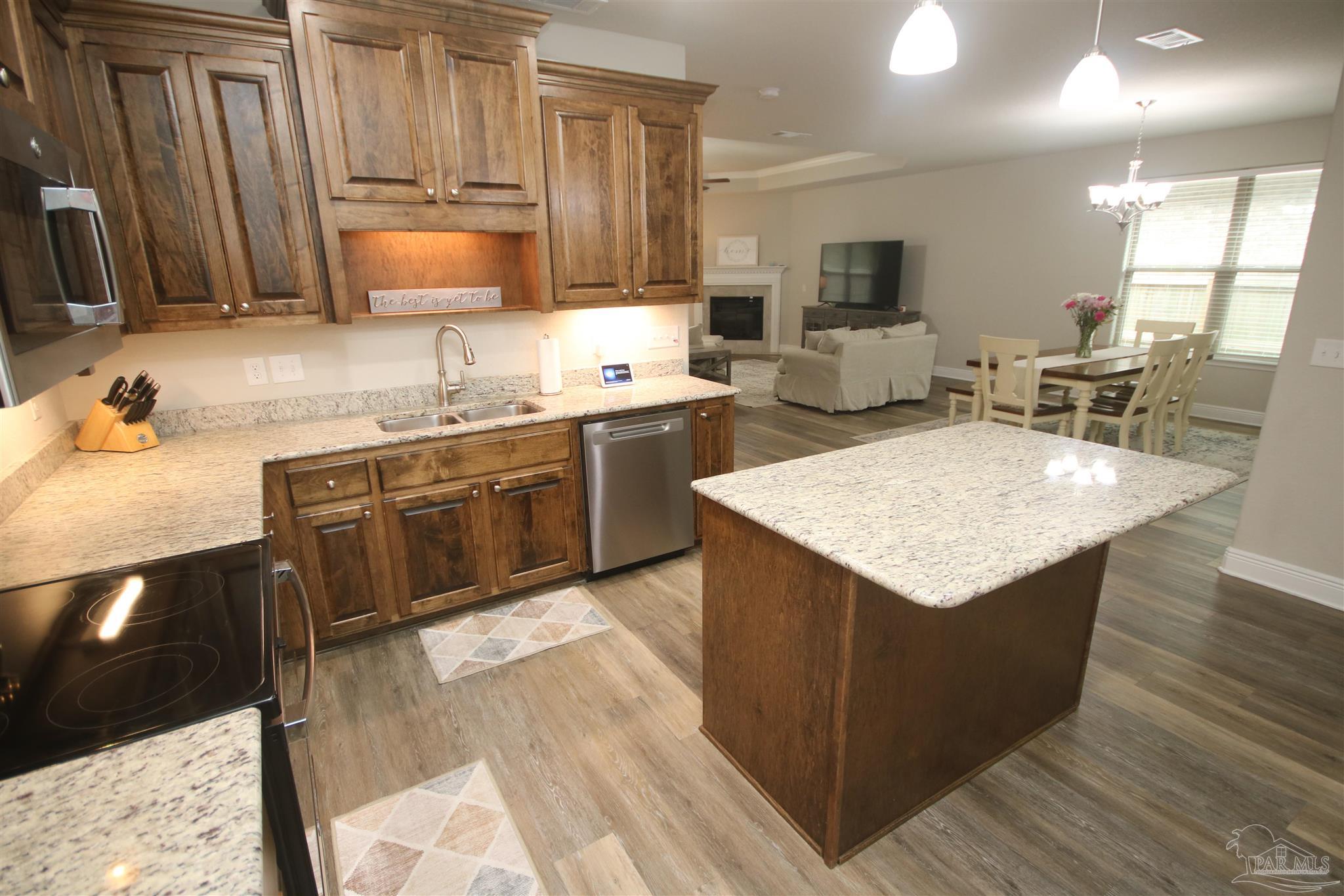 3849 Ranch Road Pace, FL 32571 - Photo 8 of 56 a kitchen with stainless steel appliances granite countertop a sink counter space cabinets and a counter top space