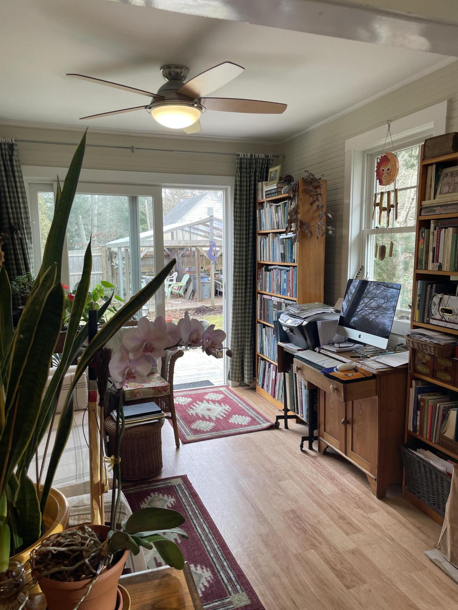 76 Camp Opechee Road Centerville, MA 02632 - Photo 16 of 37 a workspace with furniture bookshelf and a window