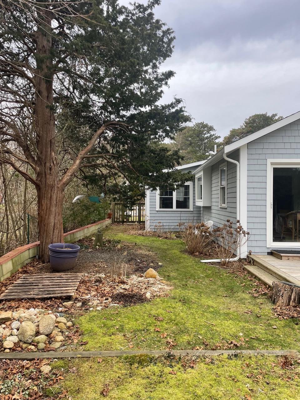 76 Camp Opechee Road Centerville, MA 02632 - Photo 24 of 37 a view of a yard with plants and a tree