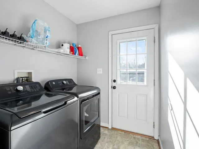 a utility room with sink dryer and washer