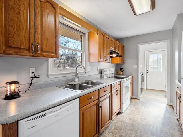 a kitchen with stainless steel appliances granite countertop a sink and a stove