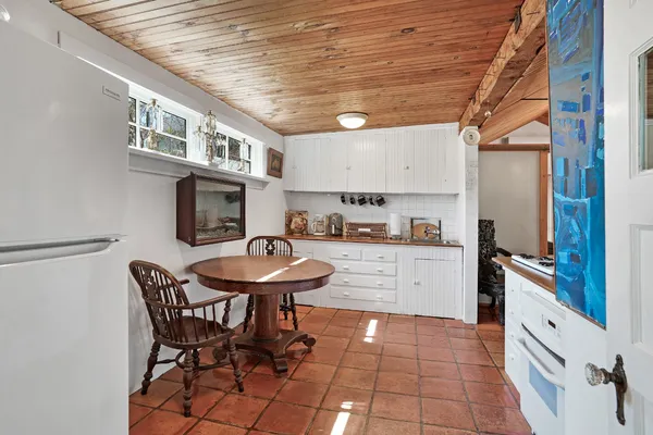 a kitchen with stainless steel appliances cabinets and a large window