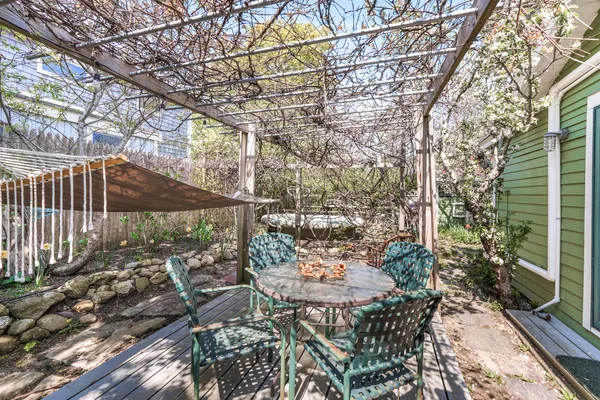 a view of a house with a patio and a yard