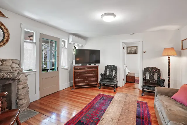 a bedroom with a bed and dresser with mirror