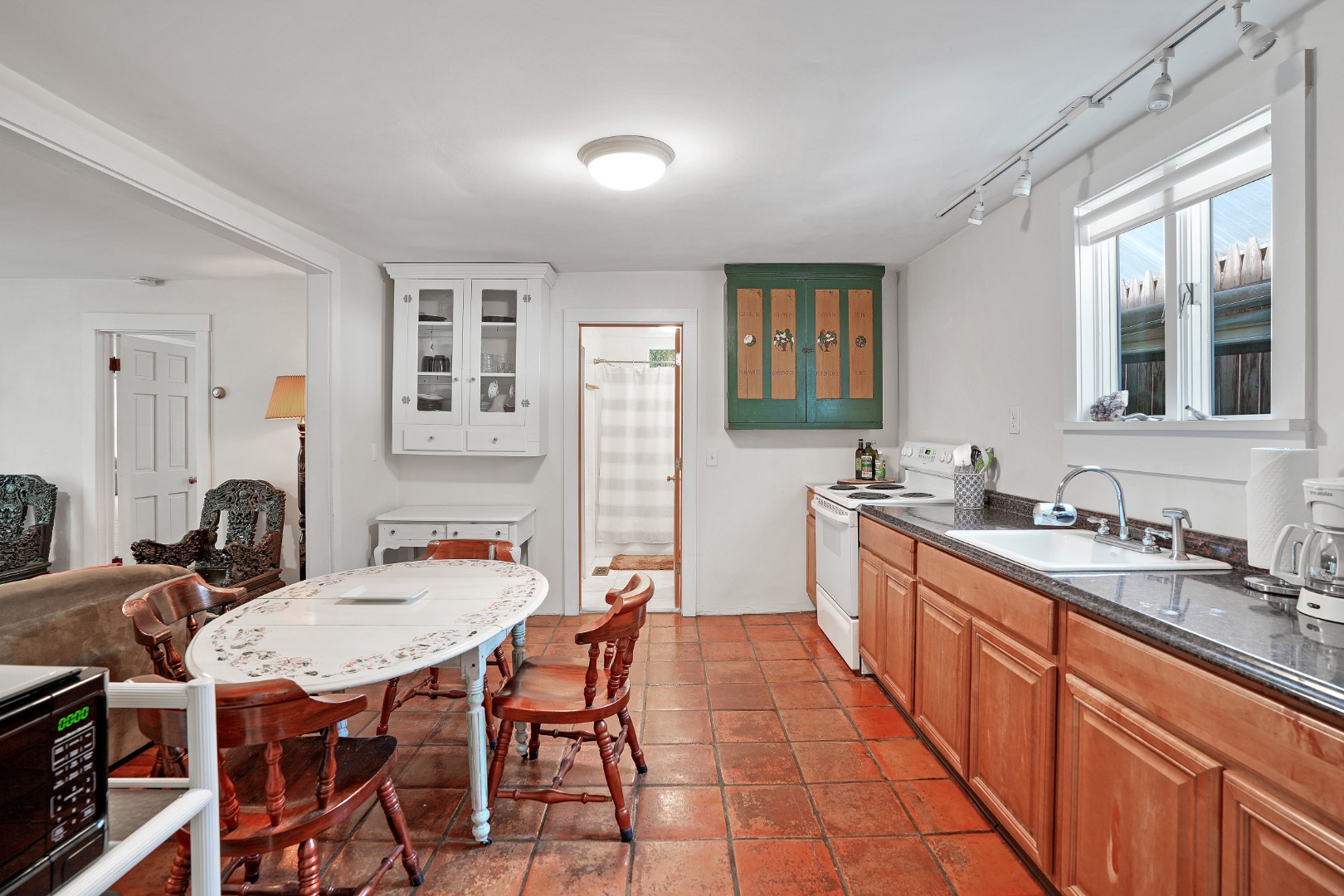 12 Maple Avenue Oak Bluffs, MA 02557 - Photo 41 of 55 a open kitchen with stainless steel appliances granite countertop a sink a stove a dining table and chairs