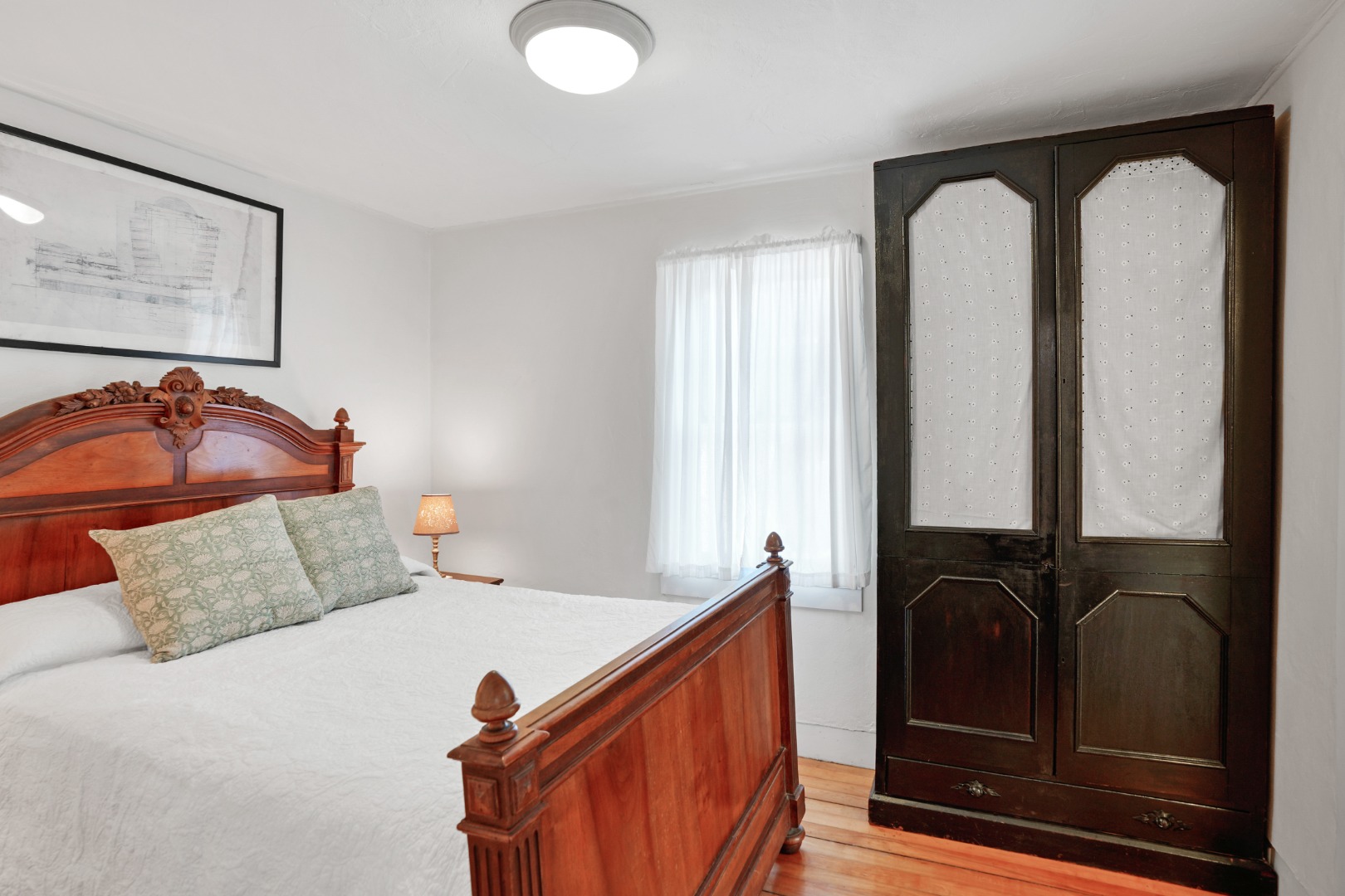 12 Maple Avenue Oak Bluffs, MA 02557 - Photo 42 of 55 a bedroom with a bed and dresser with mirror