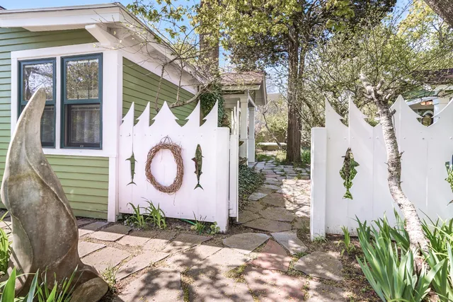 a backyard of a house with lots of green space and fountain