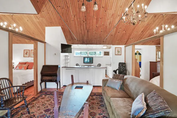 a living room with furniture a flat screen tv and large window