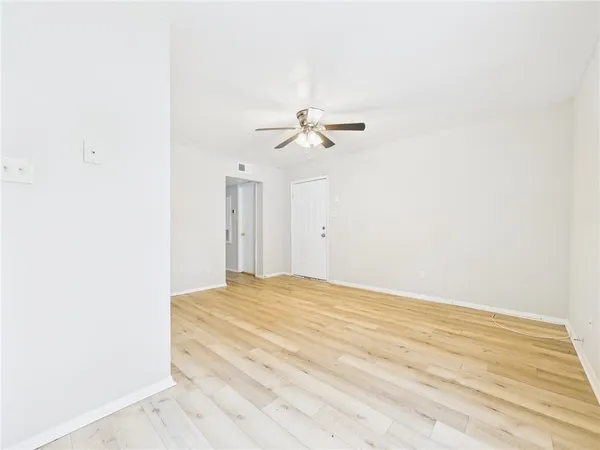 a view of a room with a ceiling fan