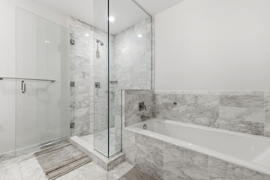 580 Washington Street, Unit 901 Boston, MA 02111 - Photo 16 of 30 a bathroom with a bathtub and a shower
