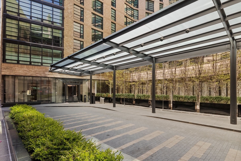 580 Washington Street, Unit 901 Boston, MA 02111 - Photo 24 of 30 a view of a patio with a table and chairs