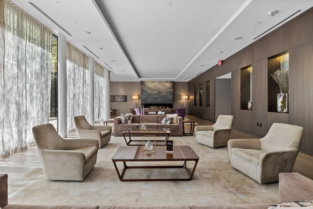 580 Washington Street, Unit 901 Boston, MA 02111 - Photo 28 of 30 a living room with furniture and a large window