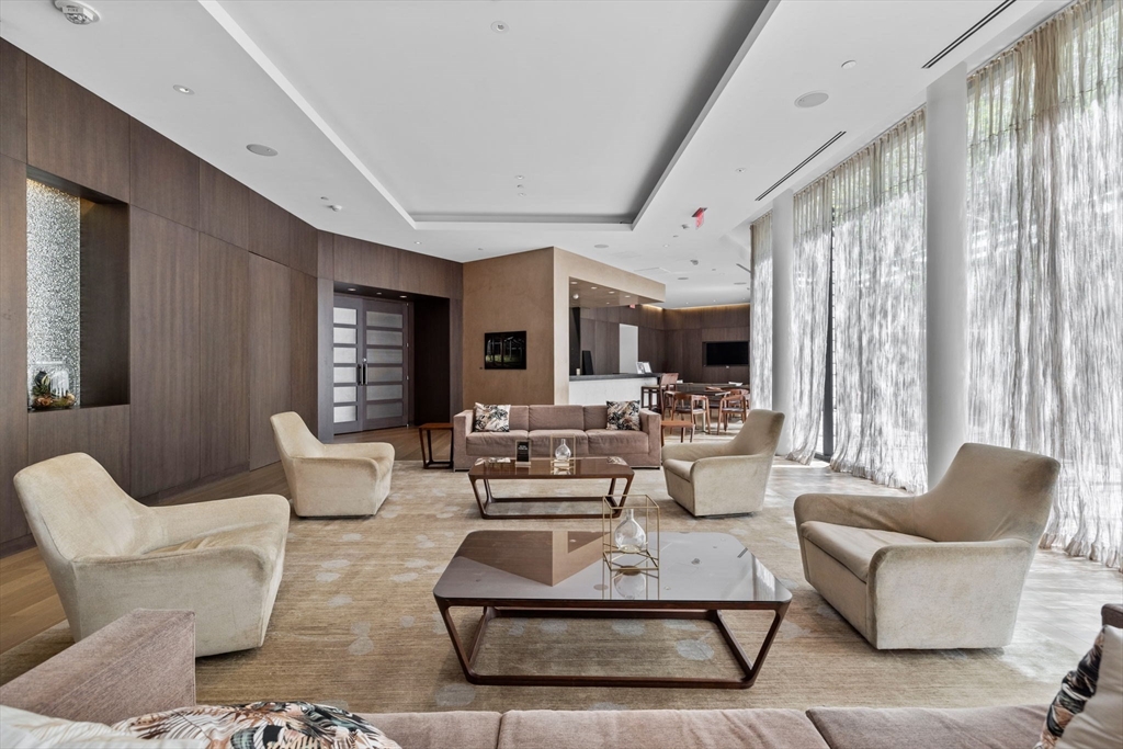 580 Washington Street, Unit 901 Boston, MA 02111 - Photo 30 of 30 a living room with fireplace furniture and large windows