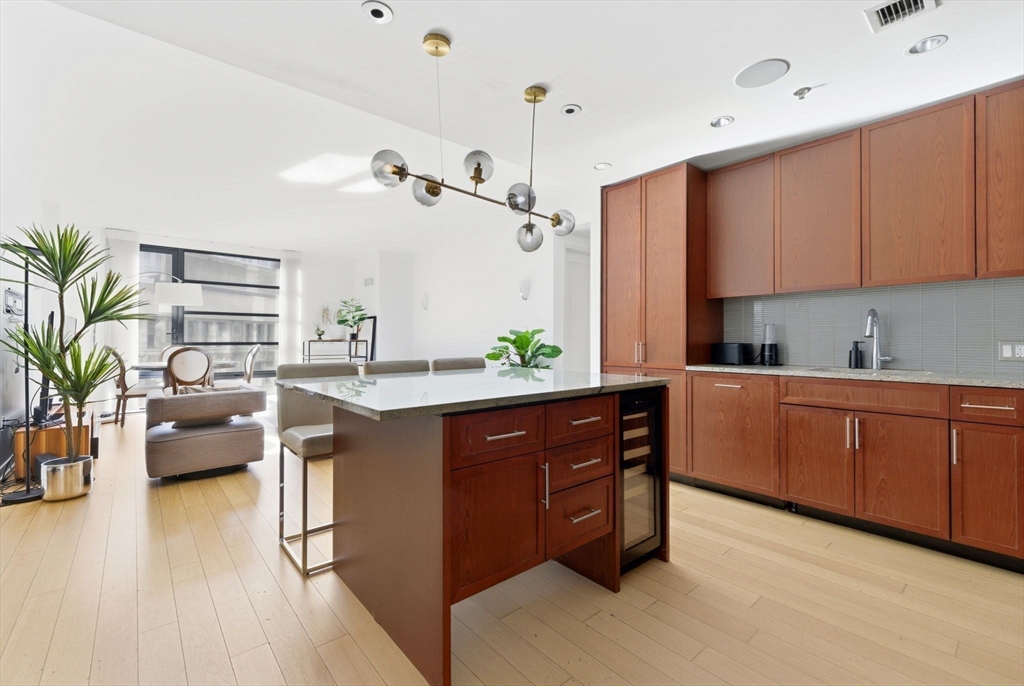 580 Washington Street, Unit 901 Boston, MA 02111 - Photo 5 of 30 a kitchen with sink and cabinets
