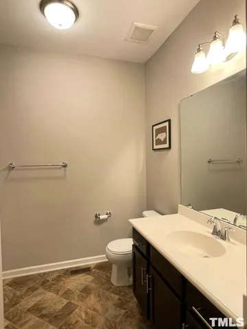 a bathroom with a sink a toilet and mirror