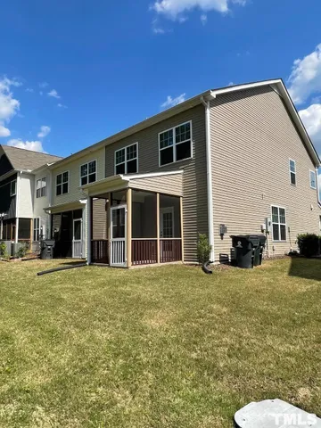 a view of a house with a big yard and large tree