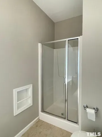 a bathroom with a shower and a sink