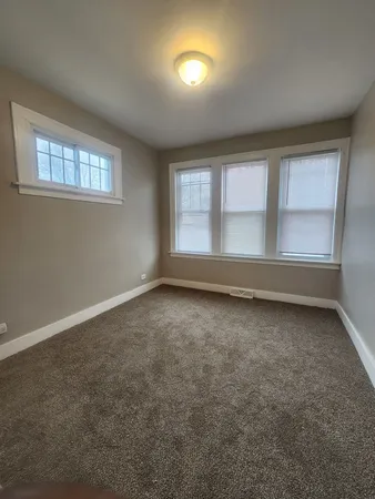 an empty room with a empty space and windows