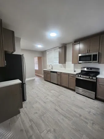 a kitchen with stainless steel appliances a refrigerator and a stove top oven