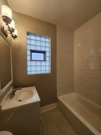a bathroom with a sink toilet and mirror