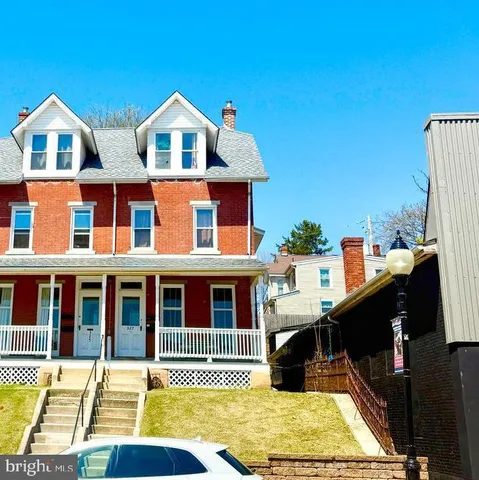 a view of a brick house with many windows