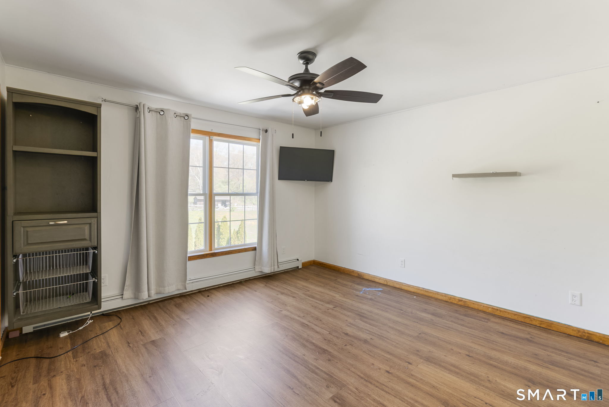 341 High Street Extension Thomaston, CT 06787 - Photo 22 of 39 an empty room with wooden floor closet fan and windows