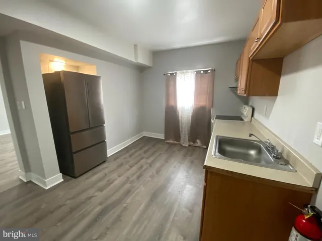 a kitchen with granite countertop a sink and a stove top oven
