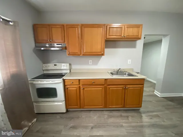 a view of a room with wooden floor