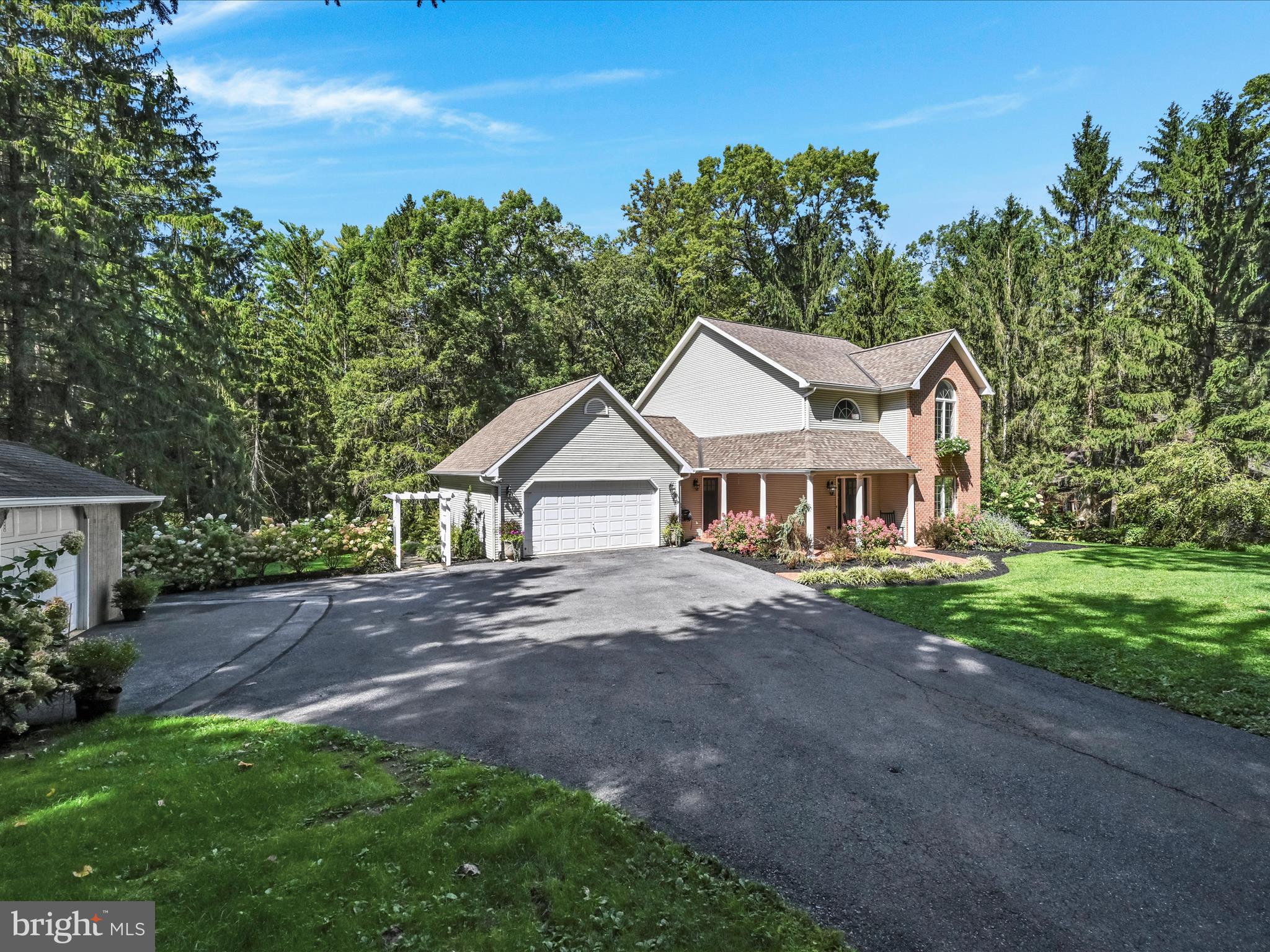 4018 Hillview Road Temple, PA 19560 - Photo 5 of 52 a front view of a house with a garden