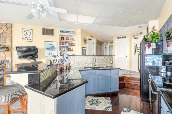 a kitchen with granite countertop a stove and cabinets