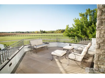 a living room with furniture and a view of kitchen