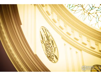 a view of a big house with a big yard and large trees