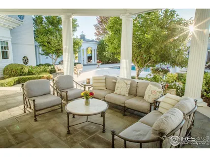 a living room filled with furniture and a floor to ceiling window
