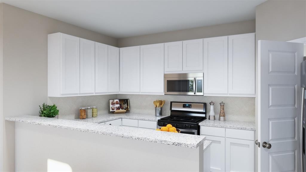 2255 Middle Rdg Drive Conroe, TX 77301 - Photo 5 of 17 a kitchen with a refrigerator a stove a microwave and cabinets