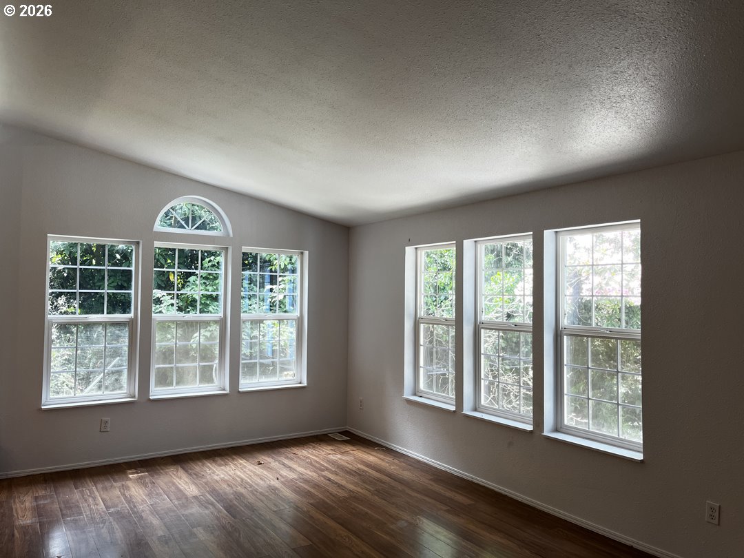 83411 Clear Lake Road Florence, OR 97439 - Photo 9 of 47 a view of an empty room with a window and wooden floor