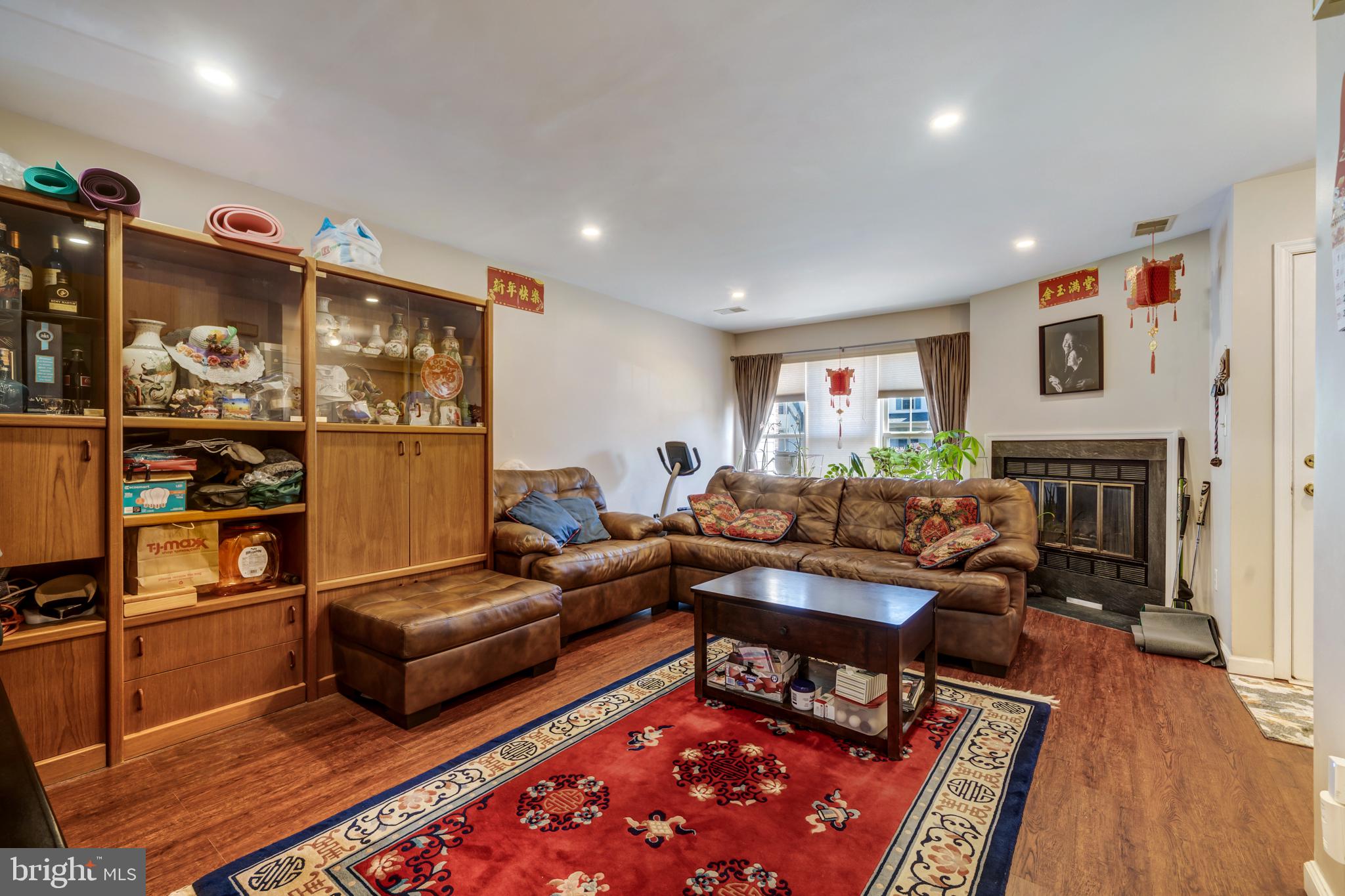 13-7 Stuart Drive Freehold, NJ 07728 - Photo 13 of 27 a living room with furniture a rug and a fireplace
