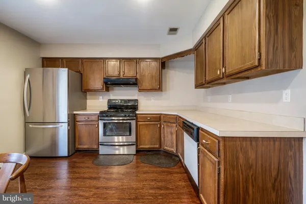 a kitchen with a refrigerator sink and cabinets