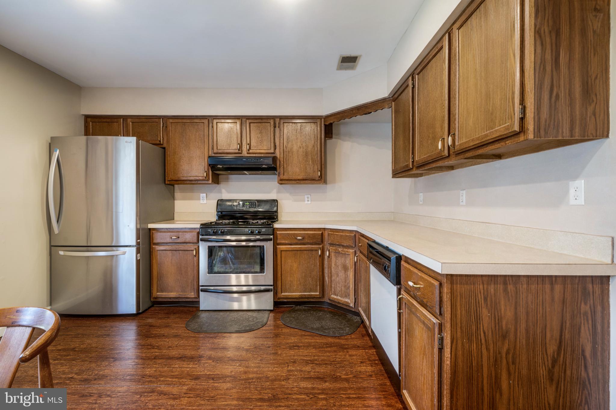 13-7 Stuart Drive Freehold, NJ 07728 - Photo 16 of 27 a kitchen with a refrigerator sink and cabinets