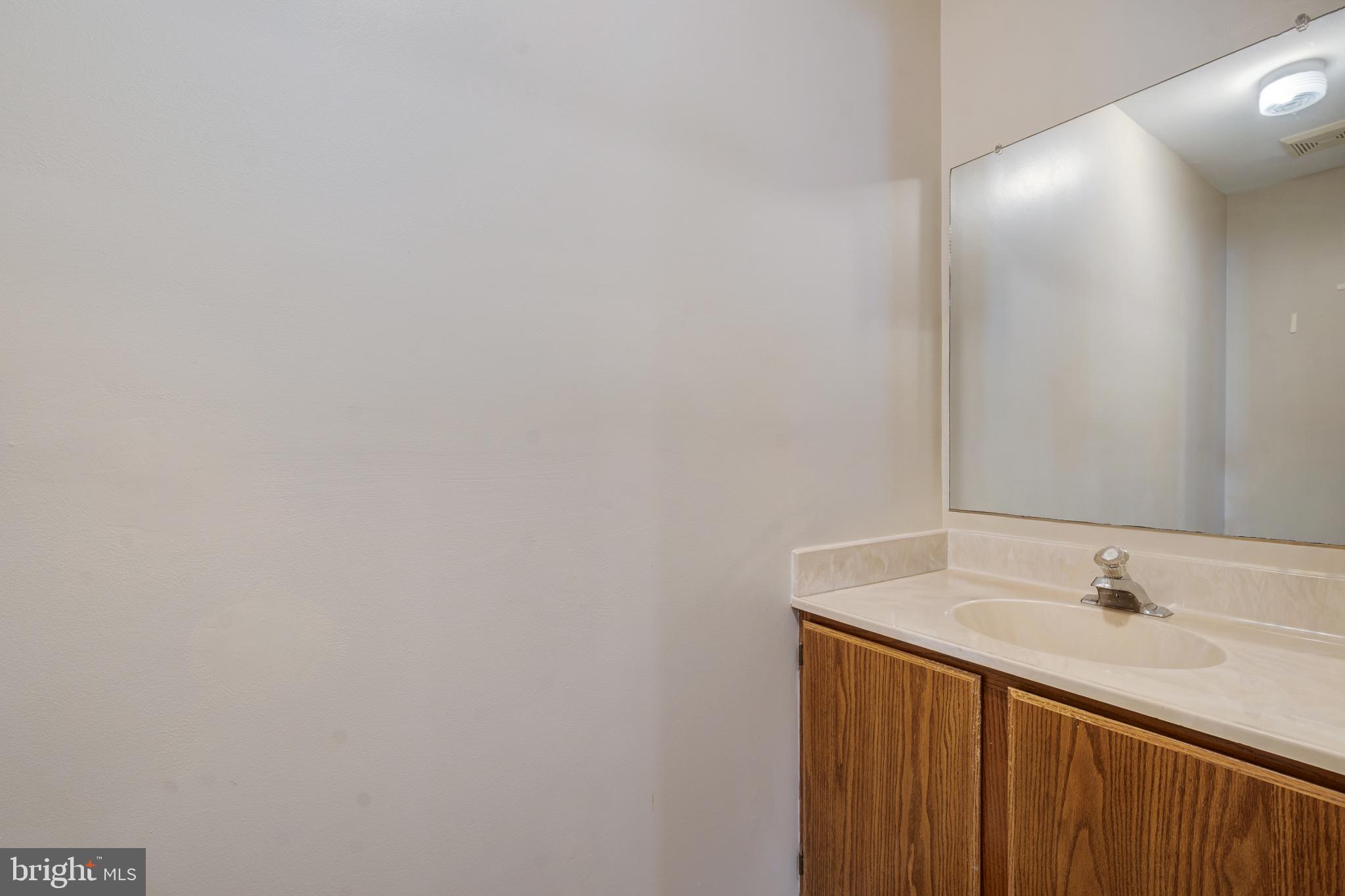 13-7 Stuart Drive Freehold, NJ 07728 - Photo 17 of 27 a bathroom with a sink and a mirror