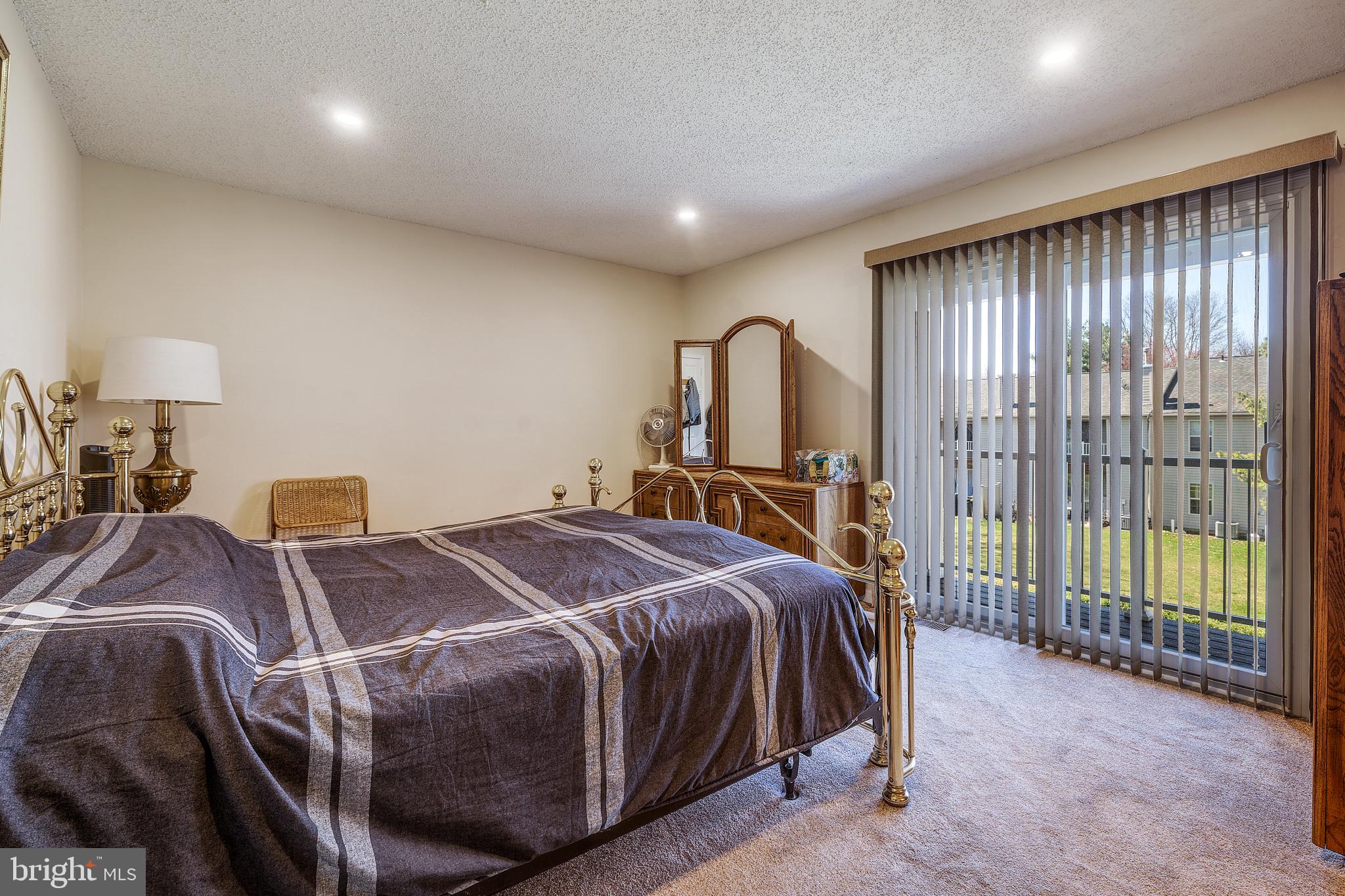 13-7 Stuart Drive Freehold, NJ 07728 - Photo 18 of 27 a bed sitting in a spacious bedroom next to a window
