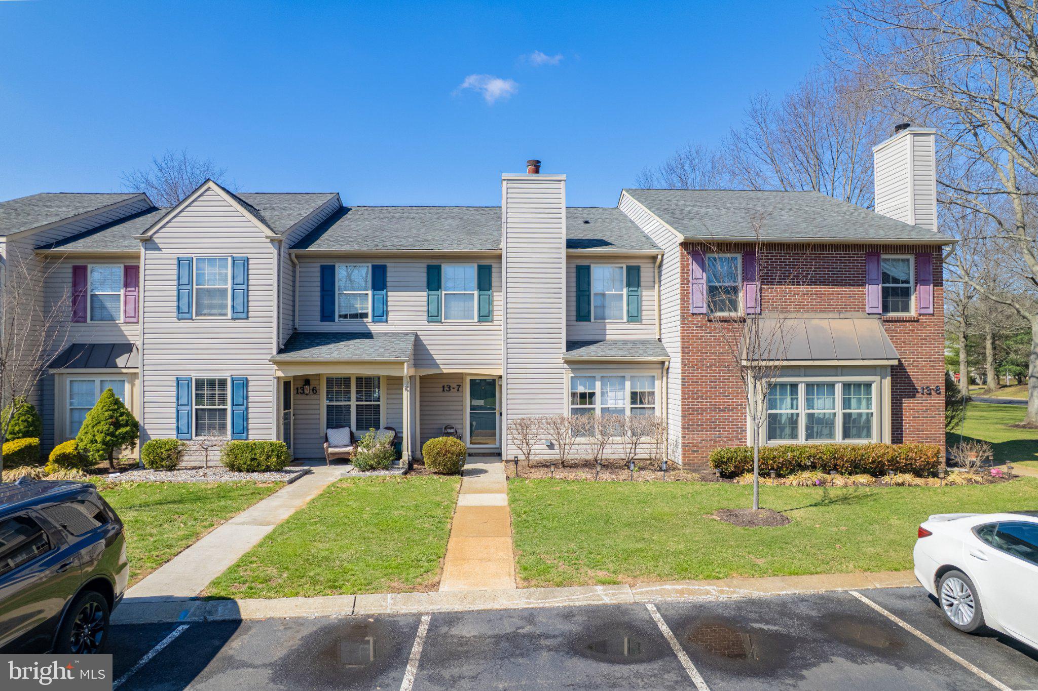 13-7 Stuart Drive Freehold, NJ 07728 - Photo 2 of 27 a front view of a house with a yard