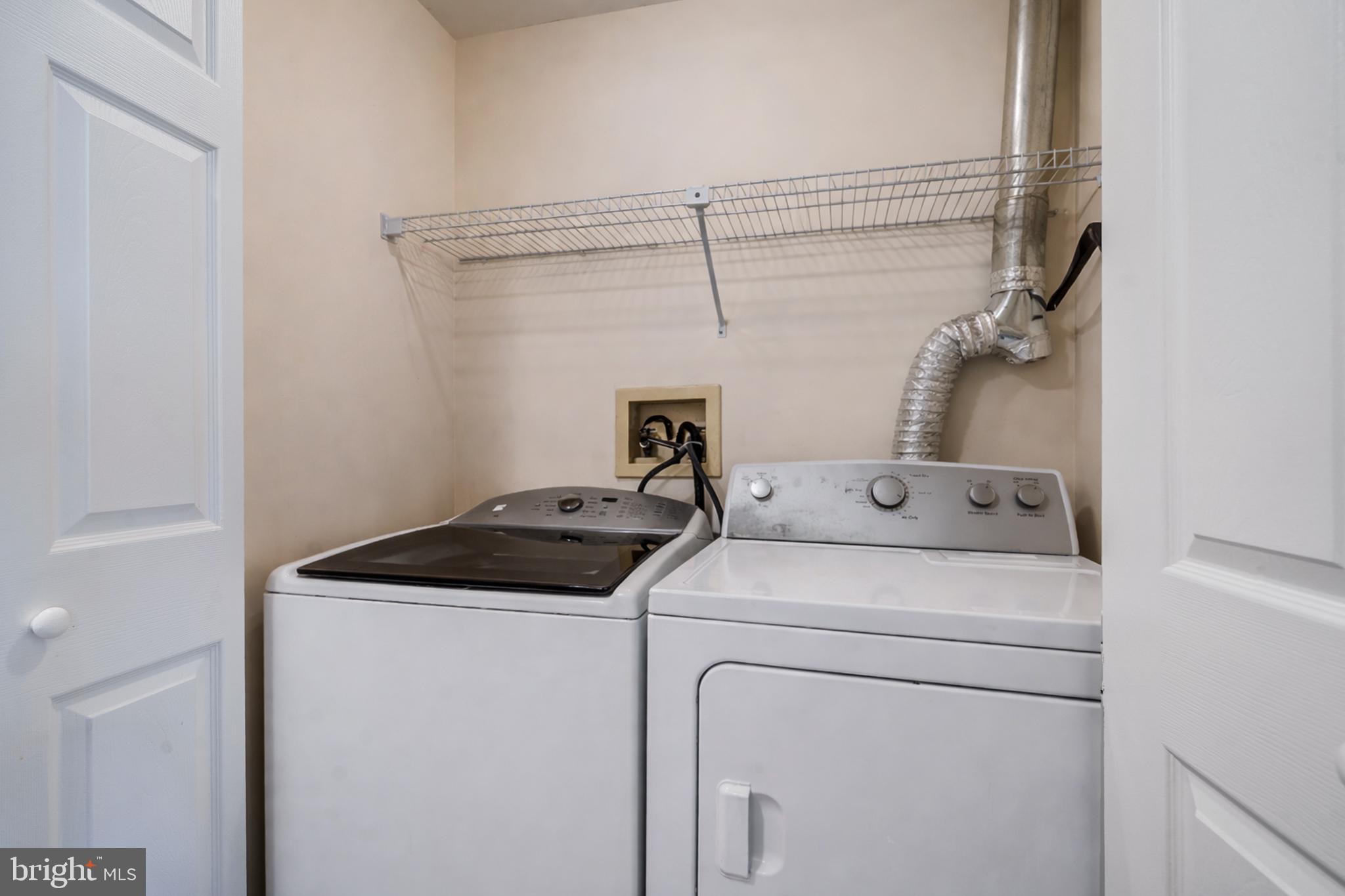 13-7 Stuart Drive Freehold, NJ 07728 - Photo 23 of 27 a utility room with dryer and washer
